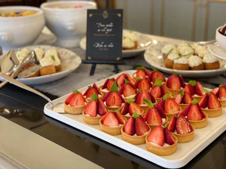 A tray of strawberry tartlets on a dessert buffet